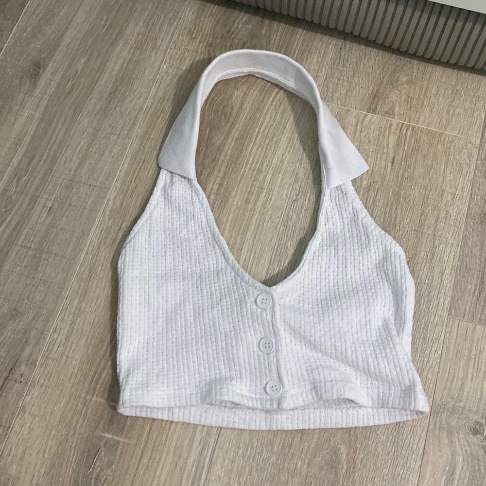 Halter neck top that buttons in the middle, flattering and tight fit.